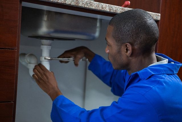 Professional plumber fitting pipework during a plumbing installation
