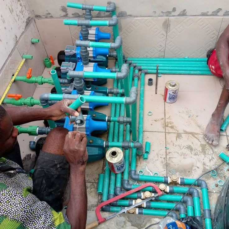 Multi-stage reverse osmosis water filtration system installed on a wall with a storage tank